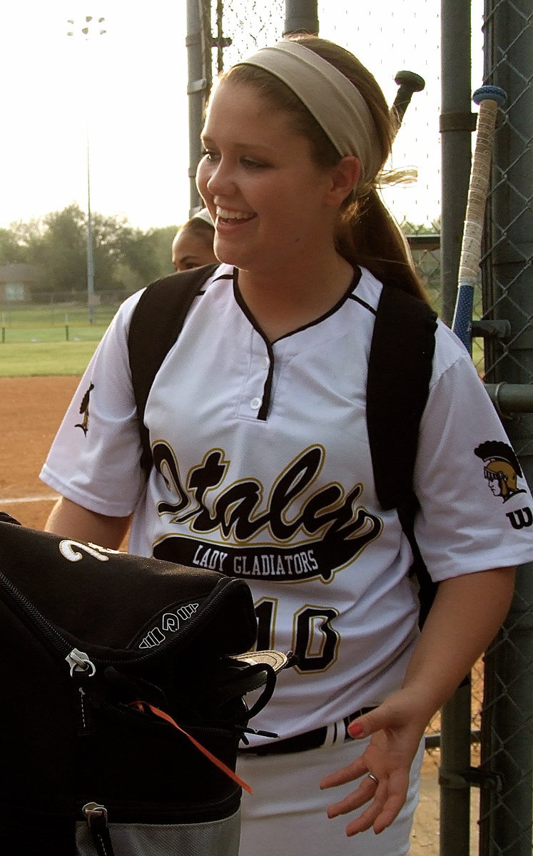 Image: Junior Paige Westbrook(10) is greeted by fans after exiting the dugout.