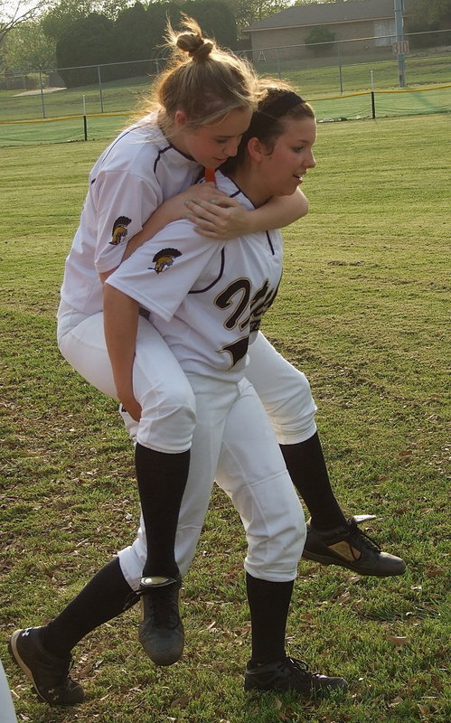 Image: Kelsey Nelson(14) gets a lift from teammate Morgan Cockerham(8) as they head into the playoffs.