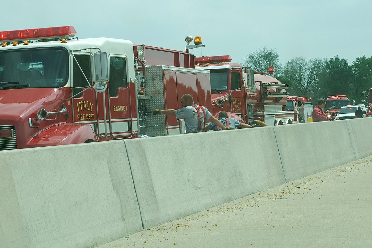 Image: Brad Chambers and his fellow Italy Firefighters keep the water flowing to fire hoses.