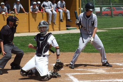 Image: Freshman catcher Ryan Connor(17) makes the stop on a low pitch.