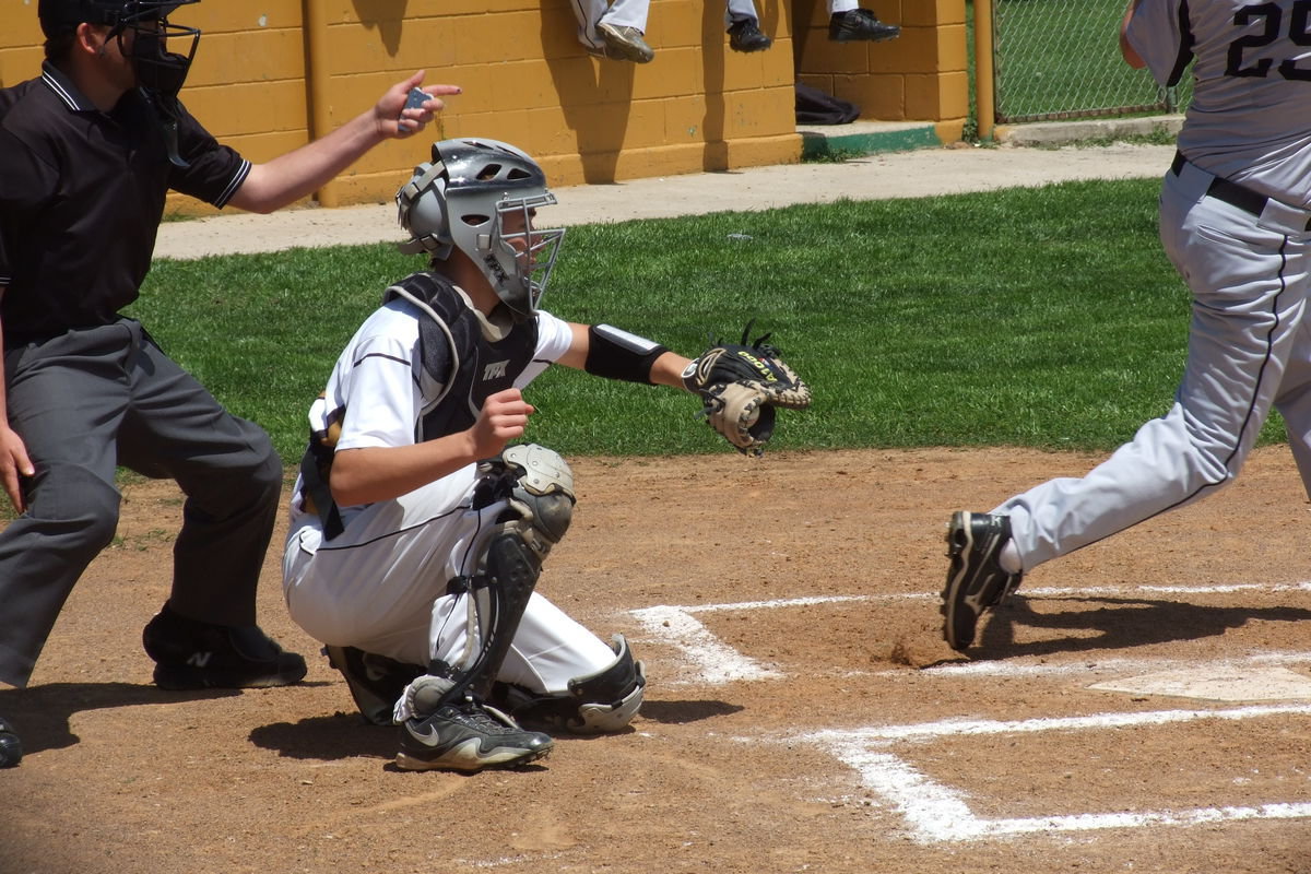 Image: Italy’s Ryan Connor(17) pulls in a swing and a miss for strike call.