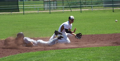 Image: A Dawson runner beats a possible tag from Italy’s senior second baseman Reid Jacinto(5).
