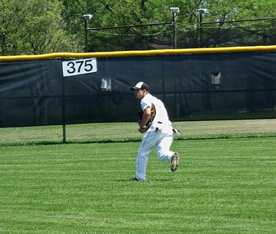 Image: Senior center fielder Chase Hamilton(10) chases after a ball hit into the left field gap.