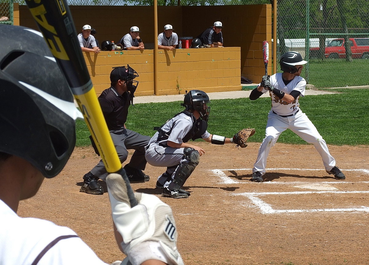 Image: Senior Reid Jacinto(5) checks out his senior cousin Caden Jacinto(2) at the plate.