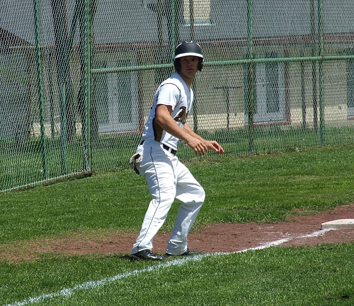 Image: Italy’s Chase Hamilton(10) looks to score form third base.