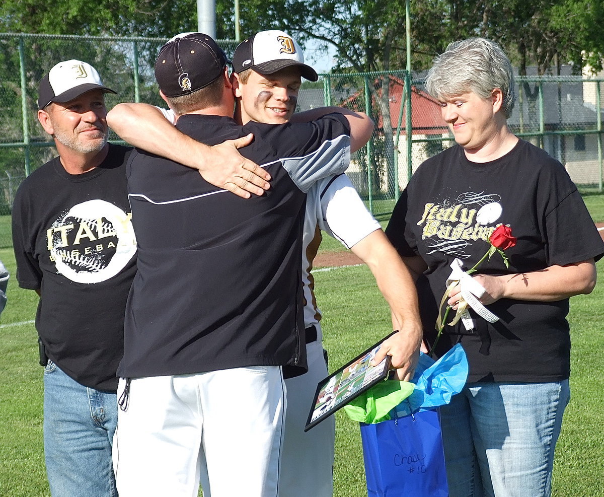 Image: Proud parents Lee and DeeDee Hamilton escort son Chase Hamilton(10), a senior, who receives a gift bag and a hug form Italy Baseball head coach Josh Ward. Aaawwww!