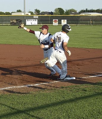 Image: ….Chase Hamilton(10) reaches first base safely after executing a perfectly placed bunt.