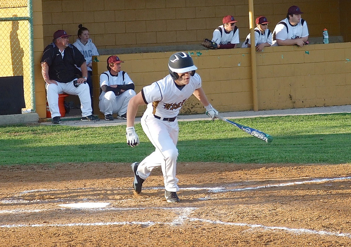 Image: Italy senior Hayden Woods(8) connects on the ball and heads toward first base.