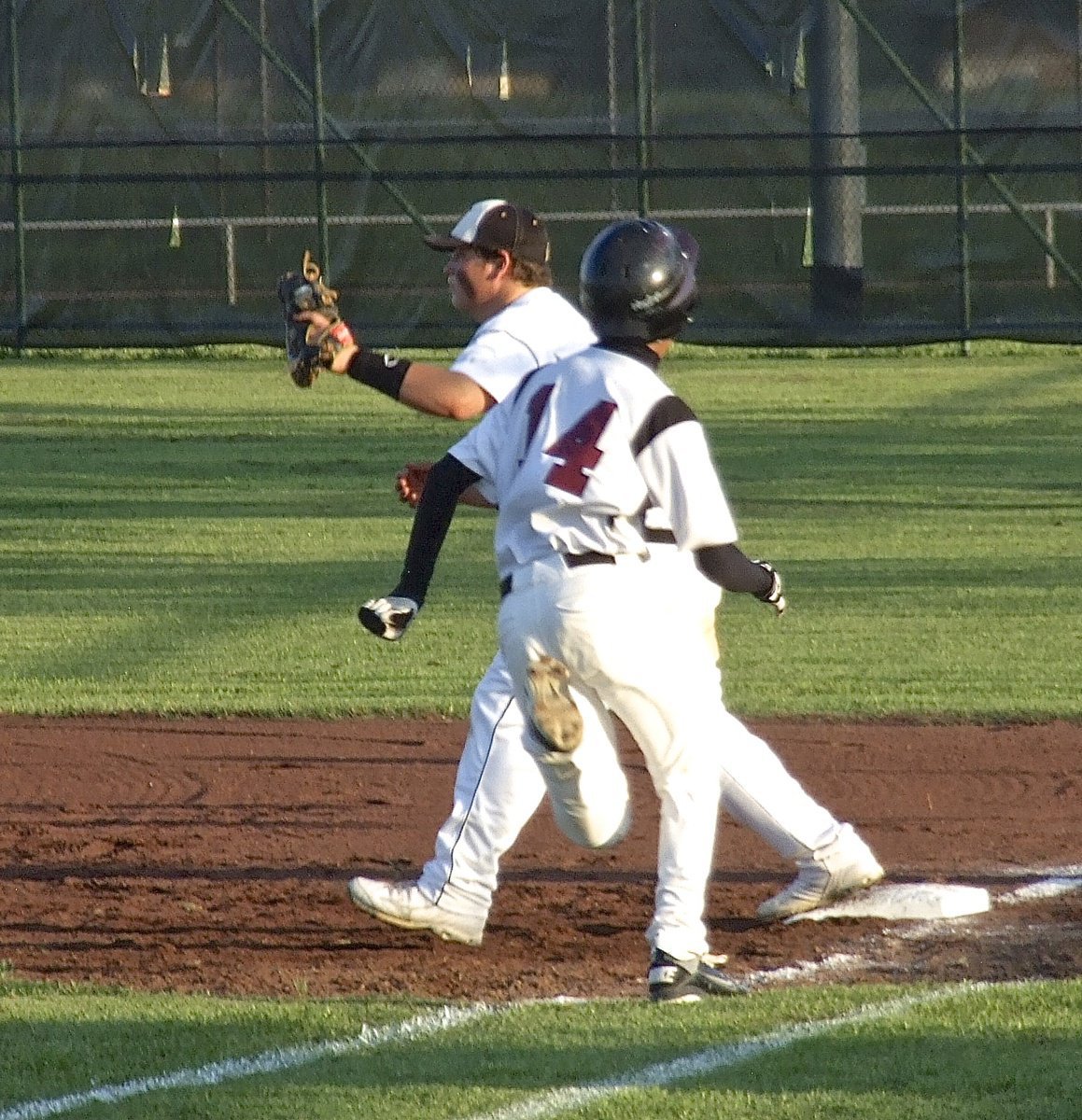 Image: Gladiator first baseman John Byers(18) secures the catch for another out at first for Italy.