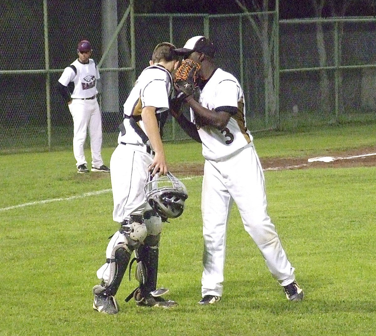 Image: Closing the deal: Senior Marvin Cox(3) and freshman catcher Ryan Connor(17) strategize to get the final strikeout to end Senior Day 2013 with Italy winning 10-4 over the Eagles.