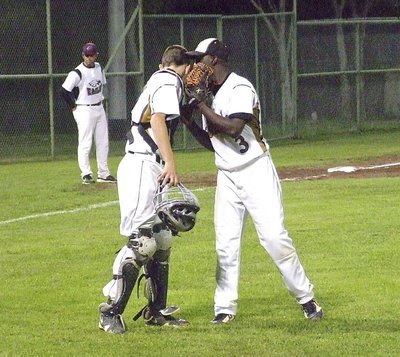 Image: Closing the deal: Senior Marvin Cox(3) and freshman catcher Ryan Connor(17) strategize to get the final strikeout to end Senior Day 2013 with Italy winning 10-4 over the Eagles.