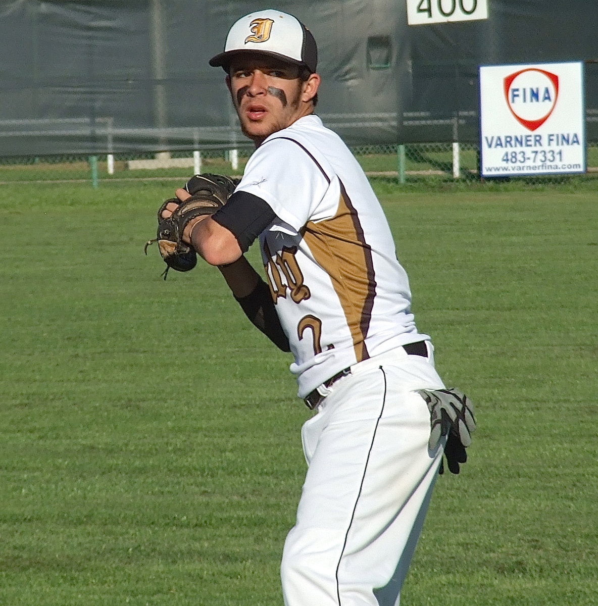 Image: Caden Jacinto(2) gets loose before taking the mound on Senior Day 2013.