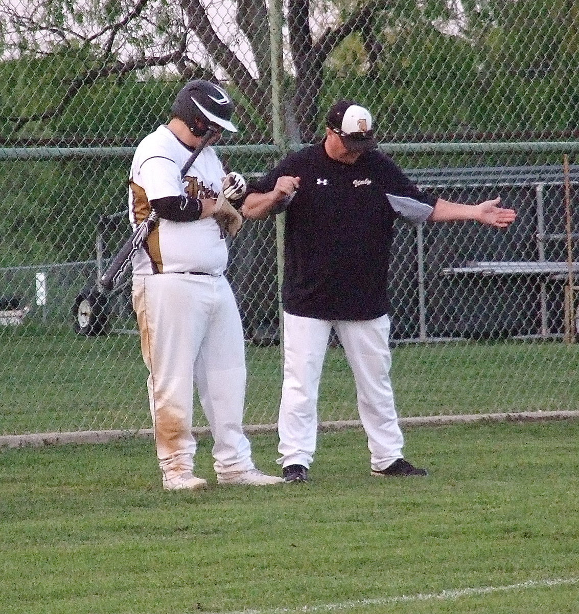 Image: Head coach Josh Ward talks technique with sophomore swing artist John Byers(18).