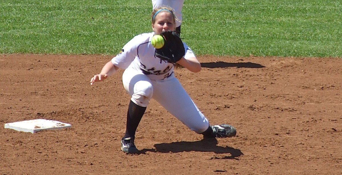 Image: Shortstop Madison Washington(2) practices a throw down with catcher Alyssa Richards.