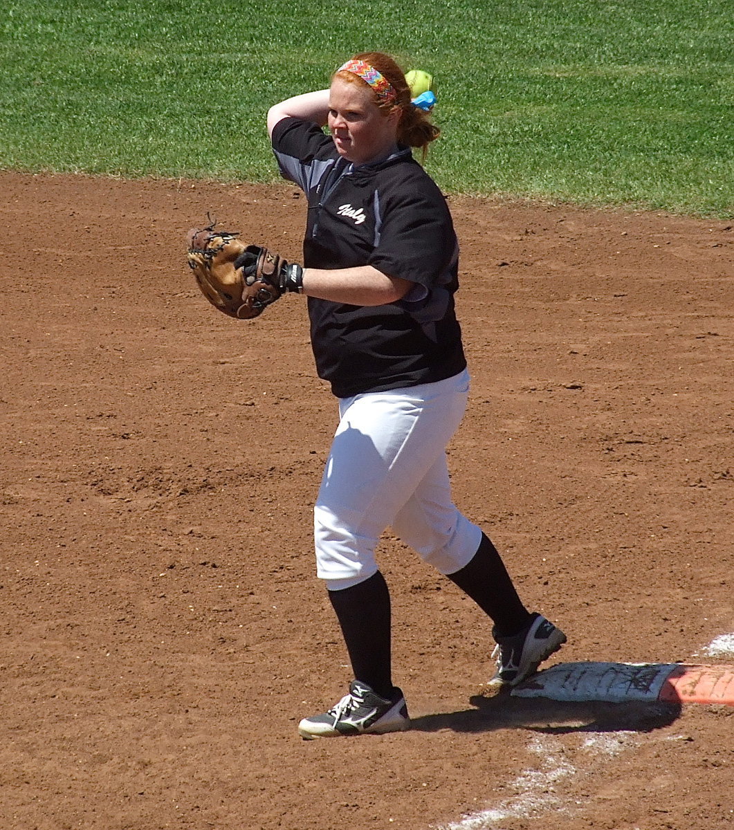 Image: Senior first baseman Katie Byers(13) warms up the infielders.