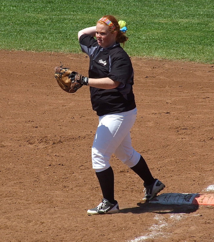 Image: Senior first baseman Katie Byers(13) warms up the infielders.