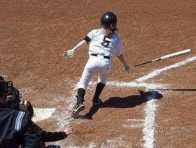 Image: Sophomore Tara Wallis(5) hits and runs to first.
