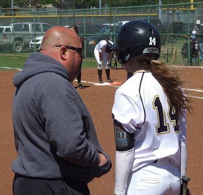 Image: Lady Gladiator head coach Wayne Rowe plots with Kelsy Nelson(14) before her at bat.