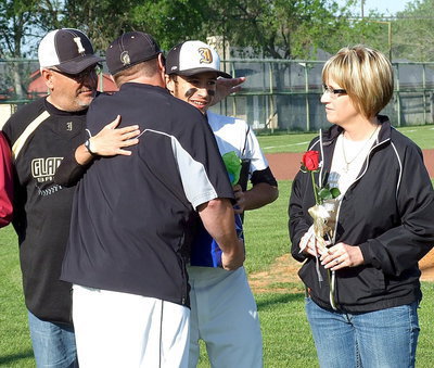 Image: Caden Jacinto(2) is escorted by his parents Vincent and Lisa Jacinto as head coach Josh Ward shows his appreciation for the senior pitcher.