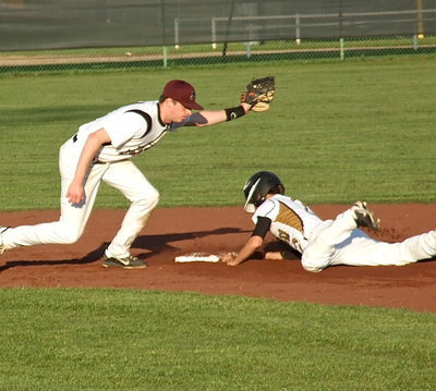 Image: Italy’s Caden Jacinto(2) slides into second beating the throw.