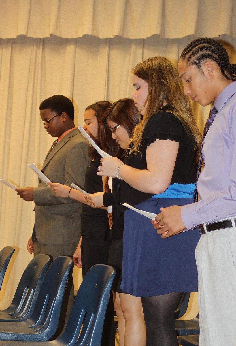 Image: Jarvis Harris, April Lusk, Kimberely Mata, Christy Murray and Devonteh Williams recite the National Junior Honor Society pledge.