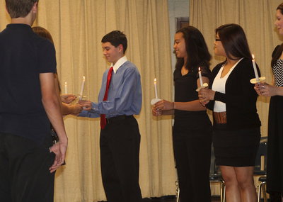 Image: Elijah Garcia accepts the flame of knowledge.