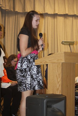 Image: Amber Hooker recites a poem for those attending the Italy National Junior Honor Society induction ceremony.