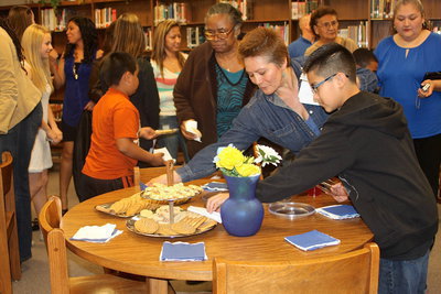 Image: Guest enjoy a reception after the ceremony inside the Italy High School library.