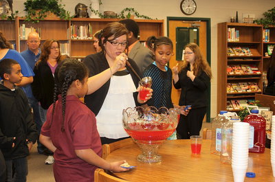 Image: Tina Richards serves up punch for guests.