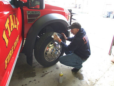 Image: Tommy Sutherland shines the tires for the memorial service.