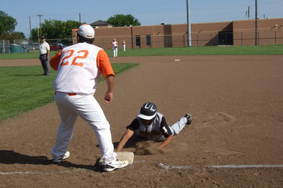 Image: Avalon’s Tim Cashion(22) holds a sliding John “Squirt” Hughes on first base.