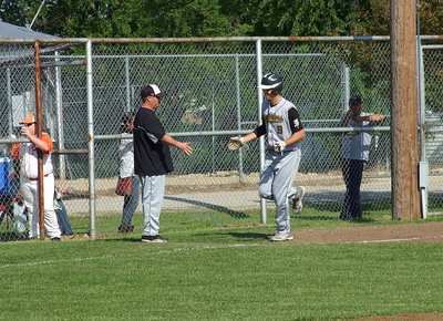 Image: Cole Hopkins gets congratulated by head coach Josh Ward as he rounds third base and then trots home to complete his, “It’s outta-here,” homer against Avalon.