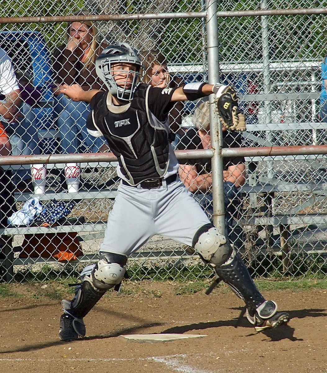 Image: Italy’s freshman catcher Ryan Connor(4) comes up throwing.