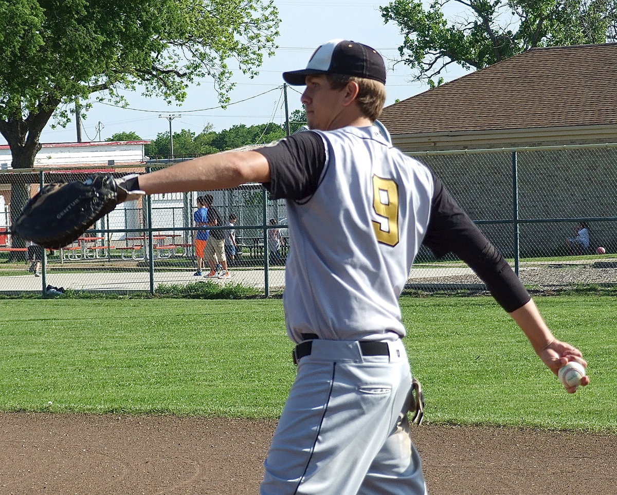 Image: Cole Hopkins(9) gets warmed up at first base.