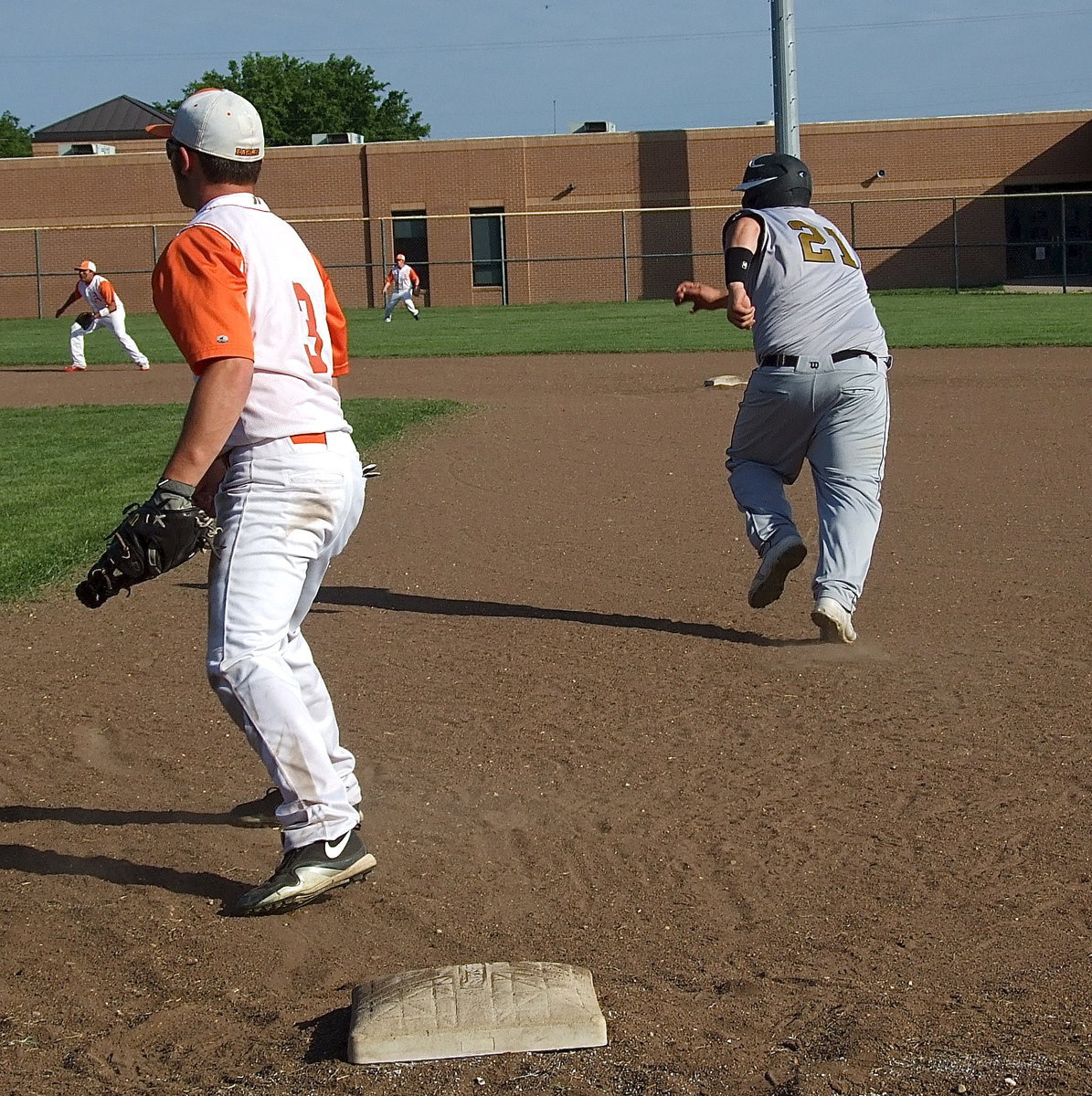 Image: Italy’s John Byers(21) reacts to a hit and races to second base.