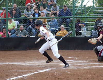 Image: Italy’s Madison Washington(2) hits and then discards the bat on her way to first base.