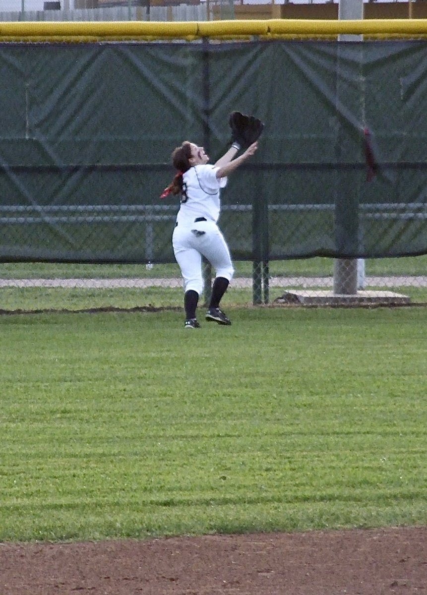 Image: Look at the grace, look at the determination as senior right fielder Morgan Cockerham(8) tries to make the catch at the wall for Italy.