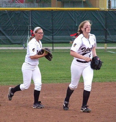 Image: Sophomores Bailey Eubank(1) and Madison Washington(2) head to the mound after warming up on defense.