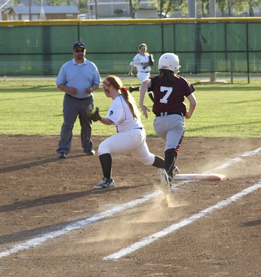 Image: Senior first baseman Katie Byers(13) makes the grab to get a Mildred Runner out while senior right fielder Morgan Cockerham(8) rushes over to back Byers up.