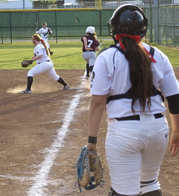 Image: Alyssa Richards(9) looks on and right fielder Morgan Cockerham(8) backs up as first baseman Katie Byers(13) makes the catch to get another Mildred runner out.
