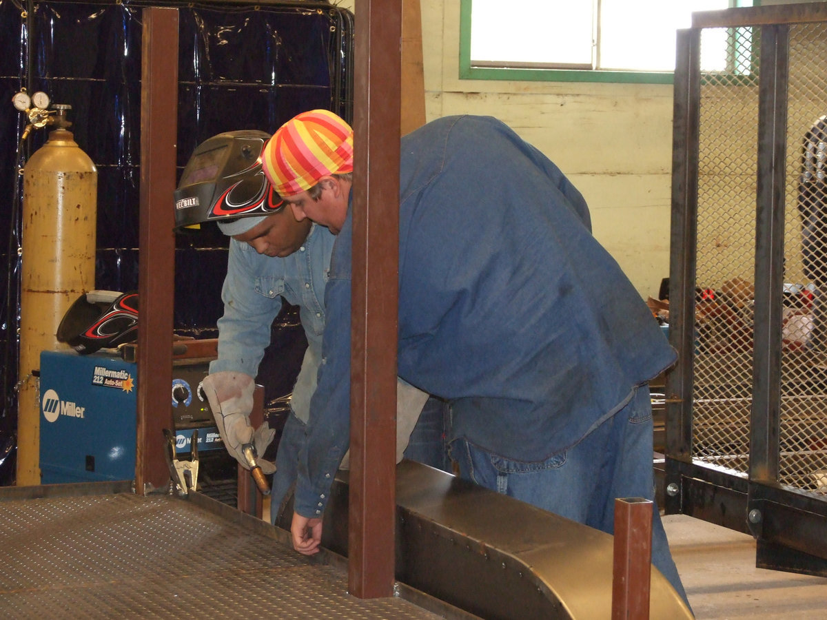 Image: Dual Credit Welding class teacher, Brian Godwin, gives student Yonathan Davilla some direction.