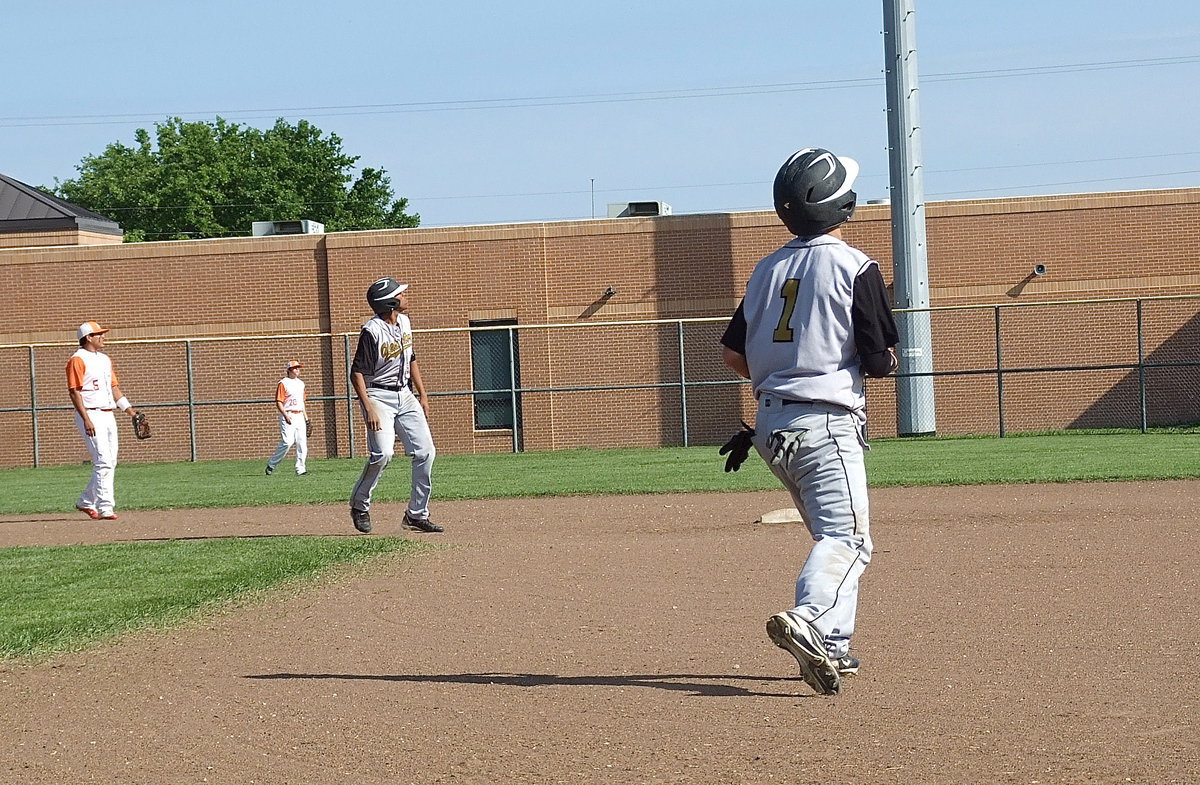 Image: Game changer: Caden Jacinto(1) and John Hughes(6) holdup with a high fly ball hit to centerfield by teammate Reid Jacinto having a chance to clear the fence.