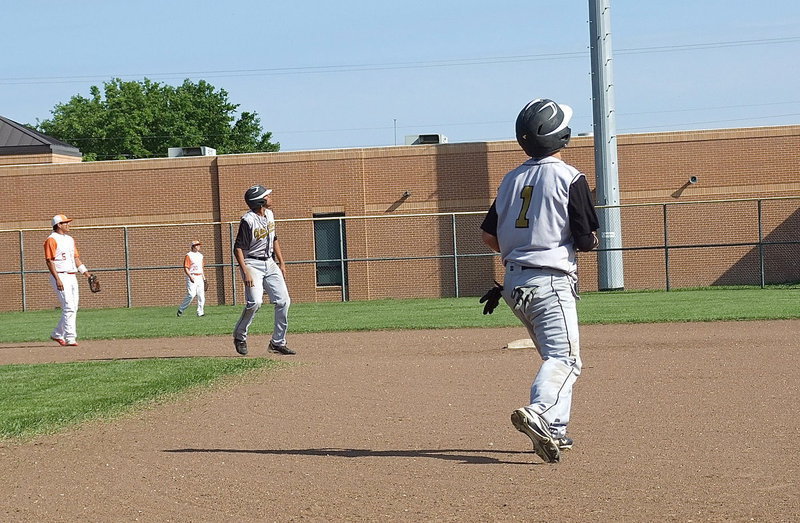 Image: Game changer: Caden Jacinto(1) and John Hughes(6) holdup with a high fly ball hit to centerfield by teammate Reid Jacinto having a chance to clear the fence.