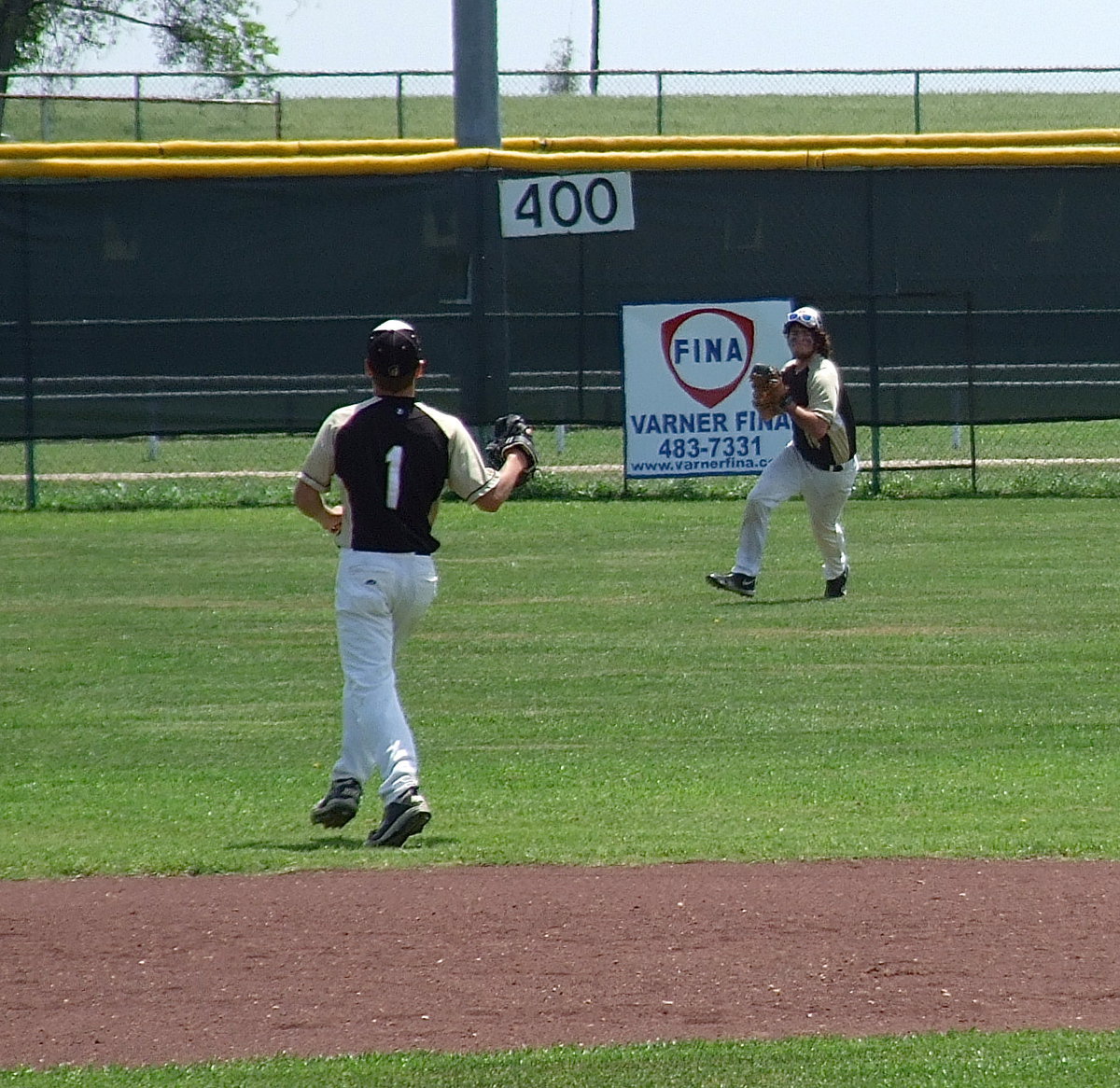 Image: Center fielder Kyle Fortenberry(14) makes the catch and then relays the throw in to Levi McBride(1).