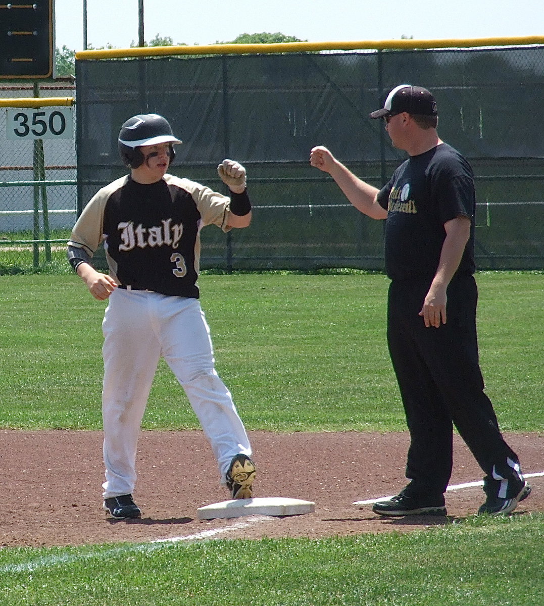 Image: A single gets John Escamilla(3) a knuckle five from Italy Baseball head coach Josh Ward.