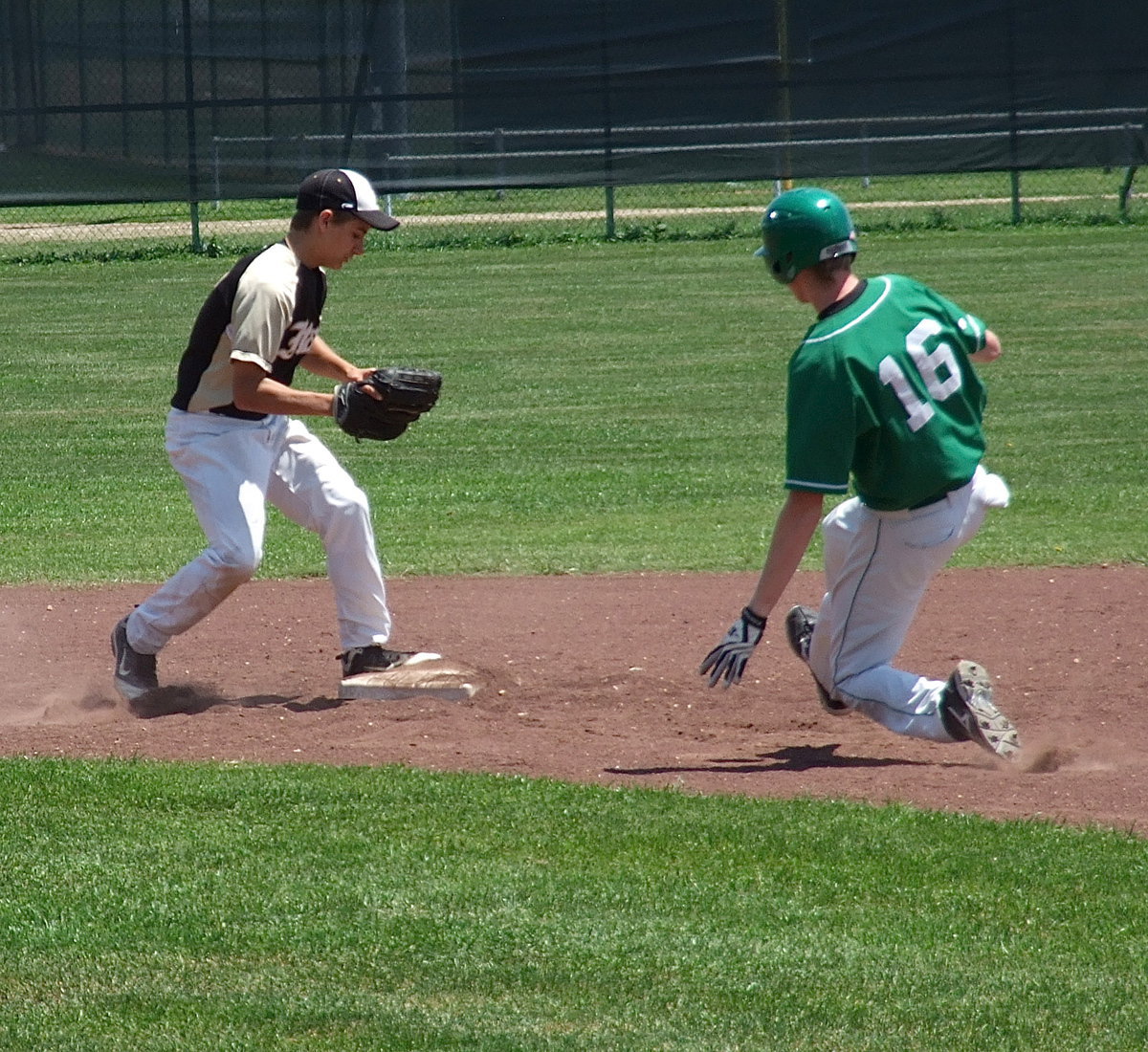 Image: Shortstop Levi McBride(1) gets the force out at second base before a Clifton runner can slide into the base.