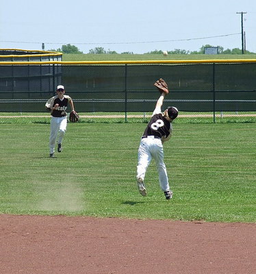 Image: Second baseman Clayton MiIler(8) stretches for a popup as Ty Windham(12) rushes in from center field.