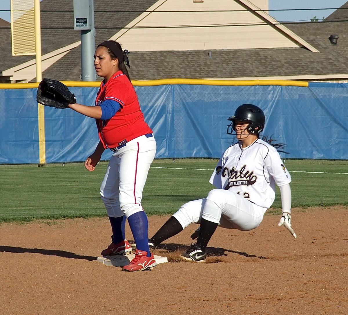 Image: Italy’s Lillie Perry(12) semi-slides safely into second base. Perry hit a double, was walked and scored twice as a pinch hitter.