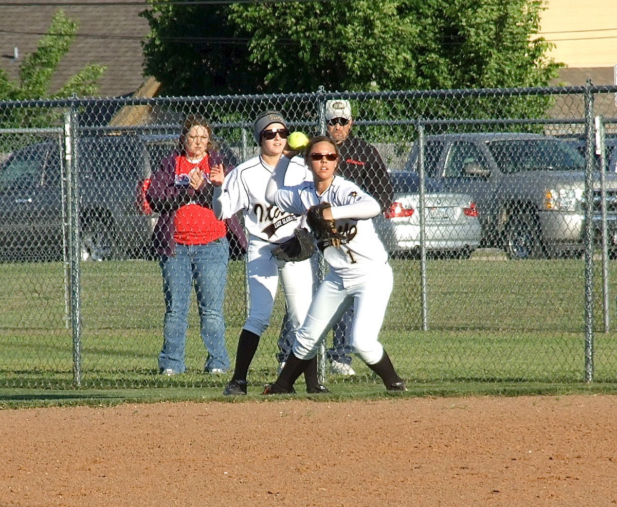 Image: Second baseman Bailey Eubank(1) tracks down a well placed popup behind first base with teammate Britney Chambers on the scene for backup.