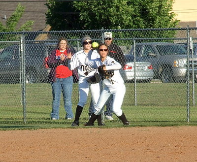 Image: Second baseman Bailey Eubank(1) tracks down a well placed popup behind first base with teammate Britney Chambers on the scene for backup.